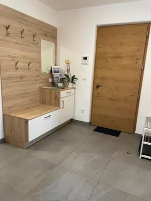 a room with a wooden door and a counter with a sink at Oberkircher in Fundres