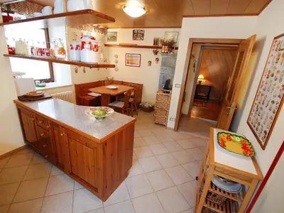 a kitchen with a wooden table and a wooden table sidx sidx sidx at Apartment Garibaldi by Interhome in Predazzo