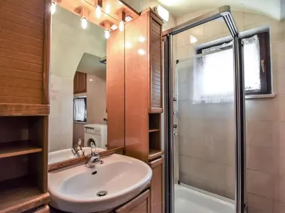 a bathroom with a toilet and a tub and a sink at Apartment Garibaldi by Interhome in Predazzo
