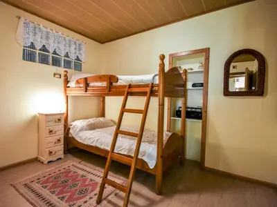 a dresser with a mirror on top of it with a dresser at Apartment Garibaldi by Interhome in Predazzo