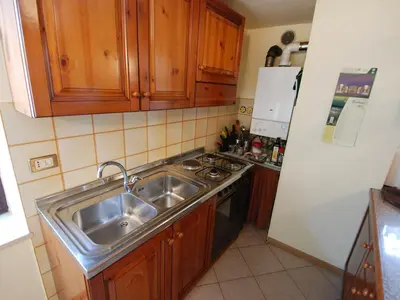 a small kitchen with a sink and a stove at Apartment Garibaldi by Interhome in Predazzo