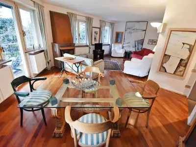 a living room with a red couch and two white chairs at Apartment Villa Esperia by Interhome in Merano