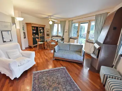 a living room with white furniture and windows at Apartment Villa Esperia by Interhome in Merano