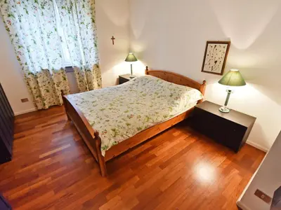 two twin beds in a room with wooden floors at Apartment Villa Esperia by Interhome in Merano