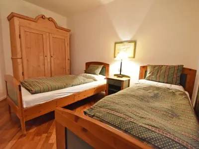 a bedroom with two beds and a lamp on a table at Apartment Villa Esperia by Interhome in Merano