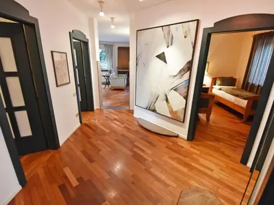 a living room with a large painting on the wall at Apartment Villa Esperia by Interhome in Merano