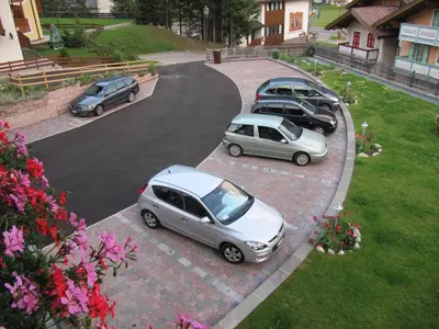 a group of cars parked in a parking lot at Garnì Villa Cecilia in Mazzin