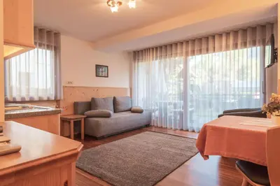 a living room with a couch and a table at Garni Residence Trocker in Castelrotto