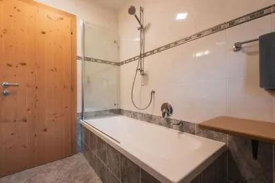 a bathroom with a tub and a shower at Garni Residence Trocker in Castelrotto