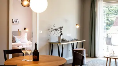 a room with a table with wine glasses on it at City Hotel Merano in Merano