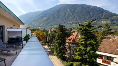 a balcony with a view of a mountain at City Hotel Merano in Merano