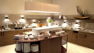 a kitchen with a table with dishes on it at City Hotel Merano in Merano