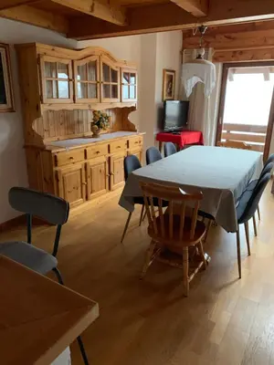 a dining room with a table and chairs at Cavalese luxury mountain and sky in Cavalese
