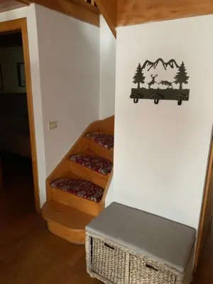 a room with three wooden risers with trees on the wall at Cavalese luxury mountain and sky in Cavalese