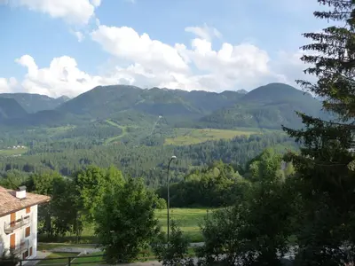 a view of a valley with mountains in the distance at Cavalese luxury mountain and sky in Cavalese