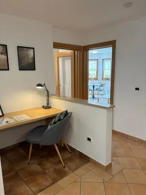 an office with a desk and a chair and a table at Obereggen - Anna in Eggen
