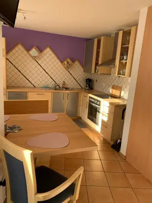 a kitchen with a wooden table in a room at Obereggen - Anna in Eggen