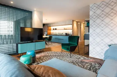 a living room with a couch and a tv at ANTON Dolomites Hideaway in Brunico