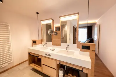 a bathroom with a white sink and a mirror at Hotel Rierhof in Chiusa