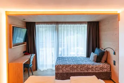 a hotel room with a bed and a window at Hotel Rierhof in Chiusa