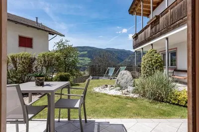 a patio with a table and chairs and a view at Panorama Residence Schlossblick in Rodengo
