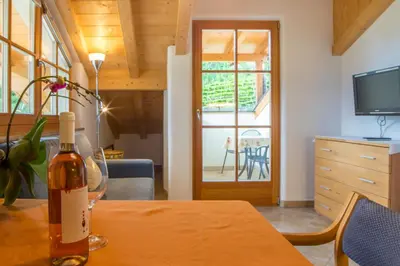 a bottle of wine on a table in a room at Weingut & Apartments Weitgruber Raffeis in Merano