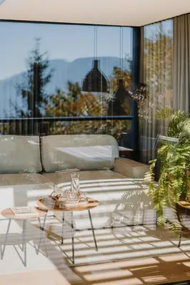 a patio with a table and a couch on a balcony at farnhaus in Tirolo