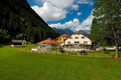 a house in front of a snowy mountain at Hotel Bad Salomonsbrunn in Anterselva di Mezzo
