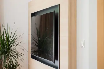 a mirror on a wall with a plant at Apartments Villa Majense in Merano