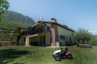 a small motorcycle parked in front of a house at Melanies Guesthouse 2 Zimmerwohnung in Caldaro