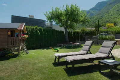 two chairs and a table in a yard at Melanies Guesthouse 2 Zimmerwohnung in Caldaro