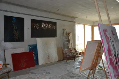 an art room with paintings on the walls at Pension Apartments Klotznerhof in Schenna