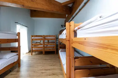 a room with a bunch of bunk beds at Rifugio Cereda in Fiera di Primiero