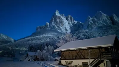 a ski lodge with a mountain in the background at Apartment Furschermuehle in Siusi