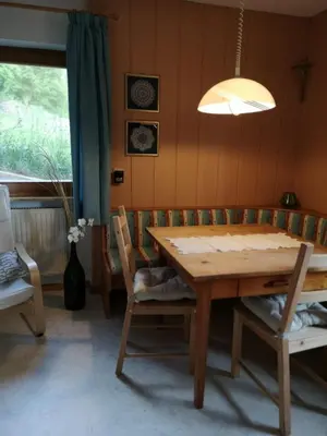 a dining room with a wooden table and chairs at Apartment Furschermuehle in Siusi