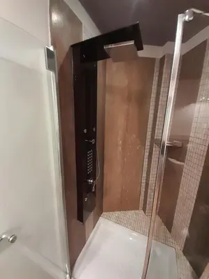 a shower with a glass door in a bathroom at Appartamento ospitale in Bolzano