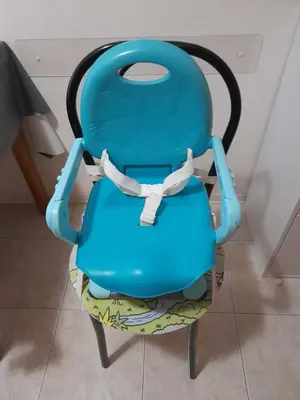 a blue chair sitting in a room at Appartamento ospitale in Bolzano