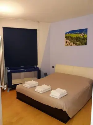a bedroom with a bed with towels on it at Appartamento ospitale in Bolzano