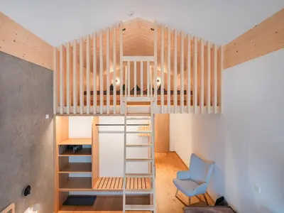 a tiny house with a ladder up to the ceiling at Steindls Boutique Favourite in Vipiteno
