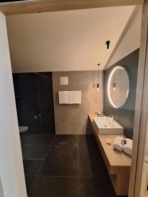 a bathroom with a sink and a mirror at Steindls Boutique Favourite in Vipiteno