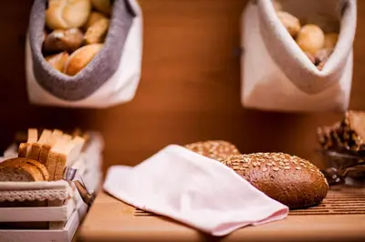 a table with bread and bags of bagels on it at Steindls Boutique Favourite in Vipiteno