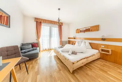 a hotel room with a bed and a couch at Pension Hatzis in Laion