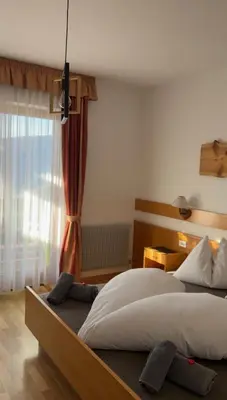 a bedroom with a large bed and a window at Pension Hatzis in Laion