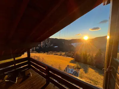 a view of the sunset from the porch of a cabin at Pension Hatzis in Laion