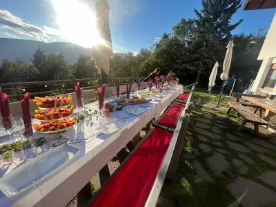 a long table with plates of food on it at Pension Hatzis in Laion