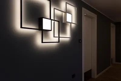 a hallway with three lights on a wall at Tourist Hotel in Bressanone