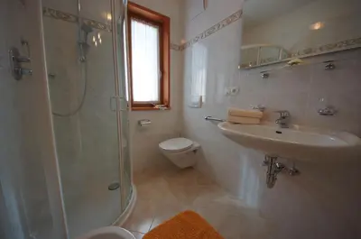 a bathroom with a shower and a sink and a toilet at Pastrogn 4 in La Valle