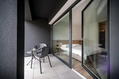 a room with a table and a bed and a mirror at Sambucus Apartments -Premium Apartments for You and Your Dog in Lana