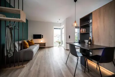 a living room with a couch and a table at Sambucus Apartments -Premium Apartments for You and Your Dog in Lana