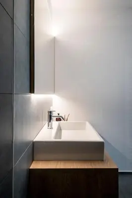 a bathroom with a white sink and a mirror at Sambucus Apartments -Premium Apartments for You and Your Dog in Lana